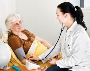 nurse helping elderly patient